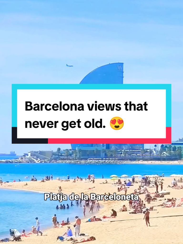 Barceloneta beach with the W Barcelona hotel by the sea.