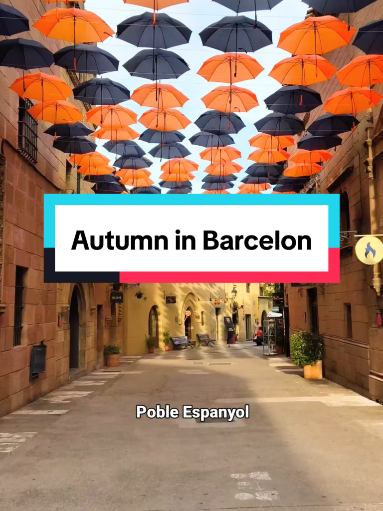 Orange and black umbrellas above a street in Poble Espanyol.