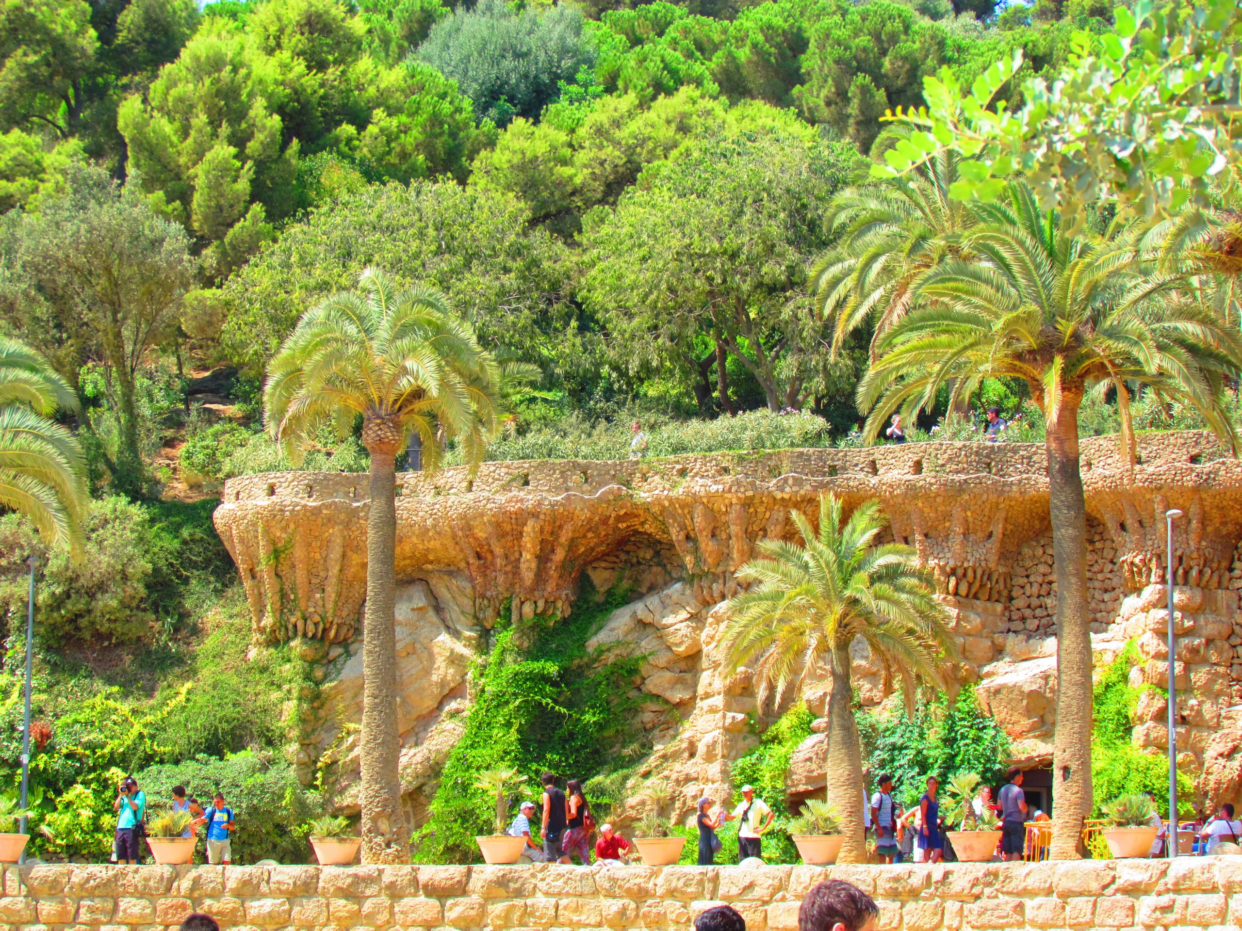 Stone viaduct and palm trees in Park Guell.