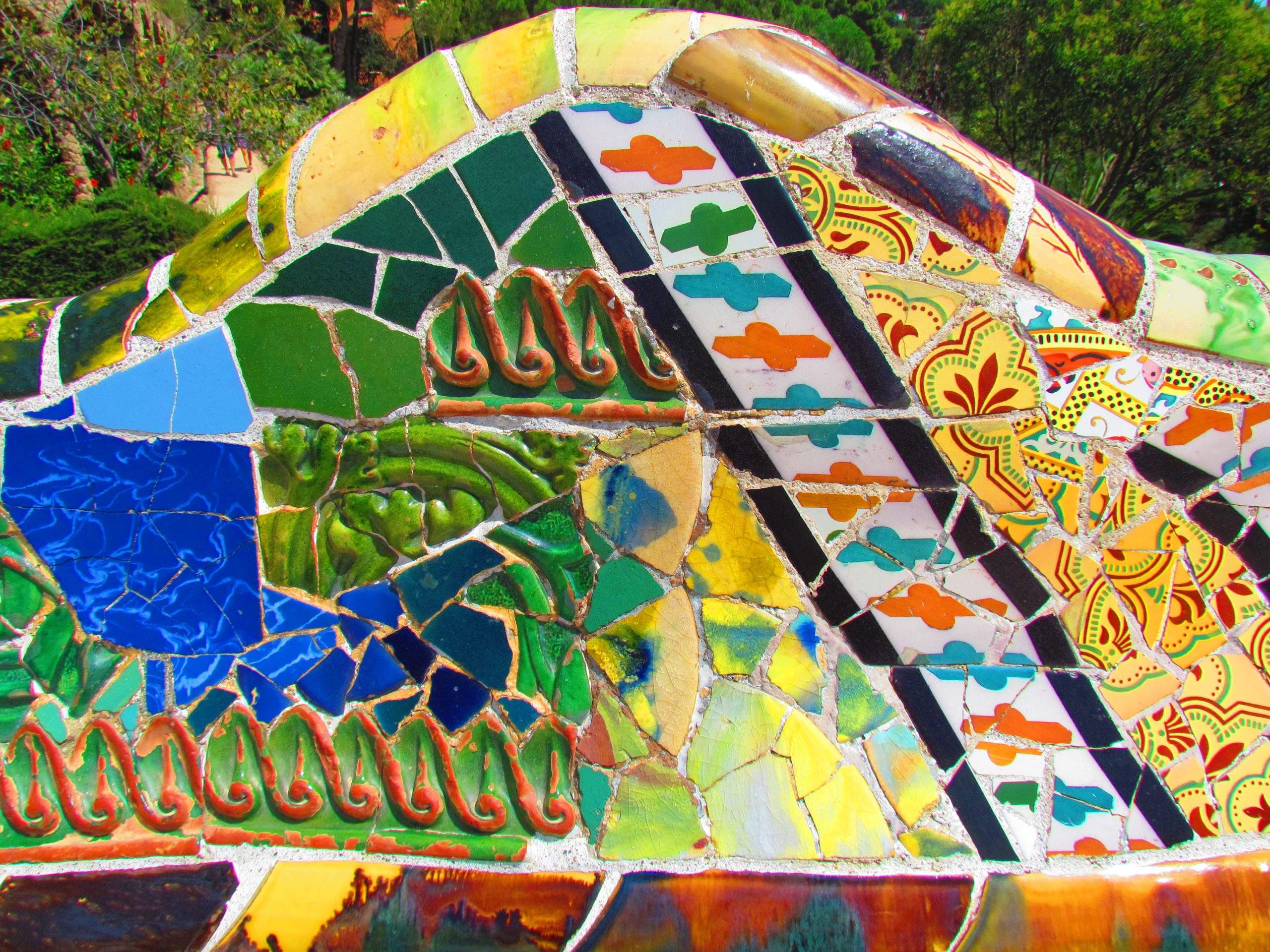 Close detail of colourful trencadis mosaic tiles at Park Guell.
