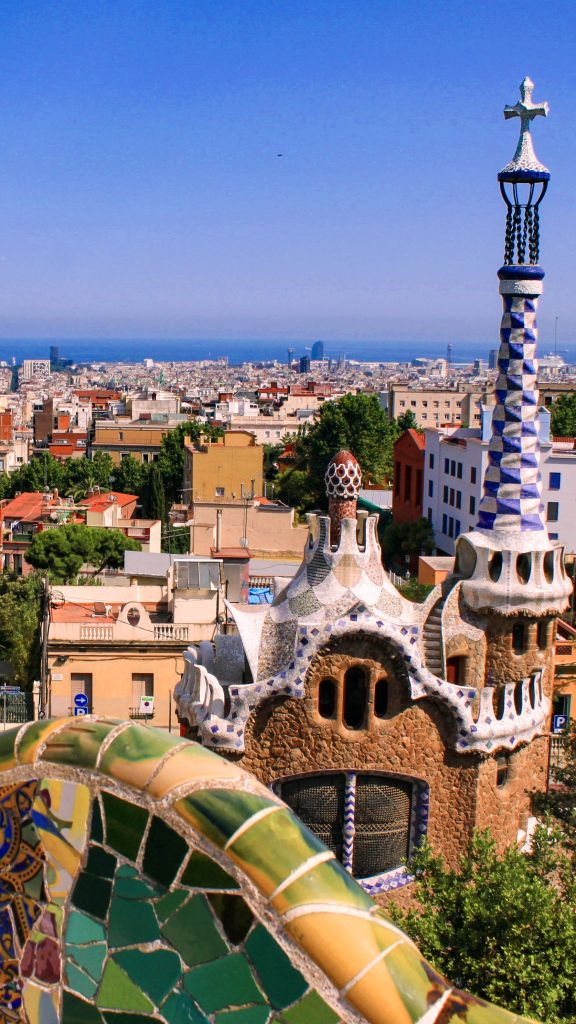 Park Guell gatehouse and Barcelona city view from the mosaic terrace.