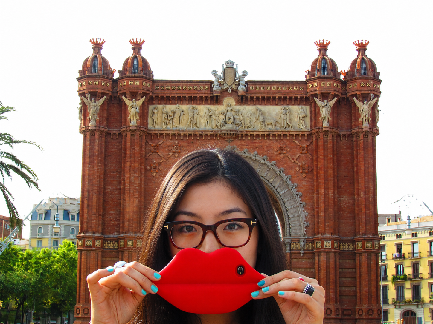 Playful portrait in front of Arc de Triomf in Barcelona.