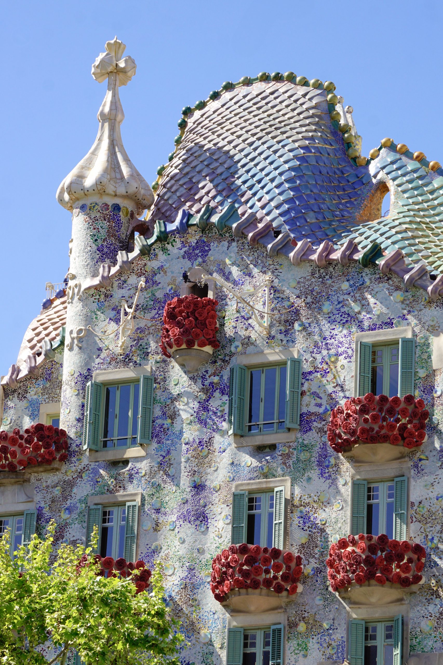 Casa Batllo facade with its dragon roof and rose-covered balconies in Barcelona.